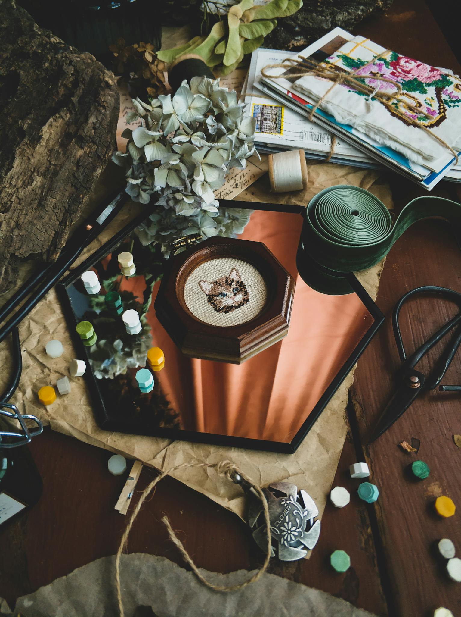 Aesthetic arrangement of embroidery tools and materials on a table.